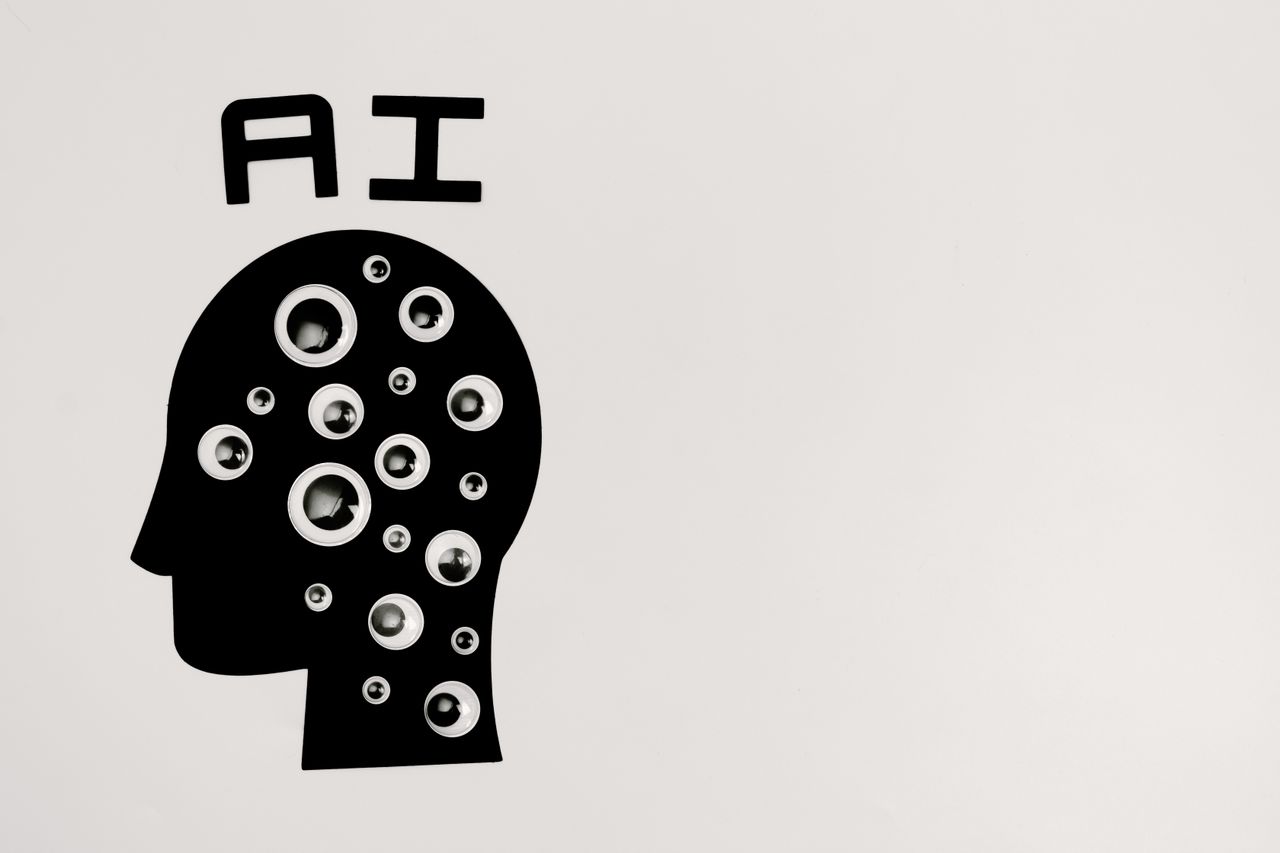 AI concept with a human head silhouette and multiple eyes